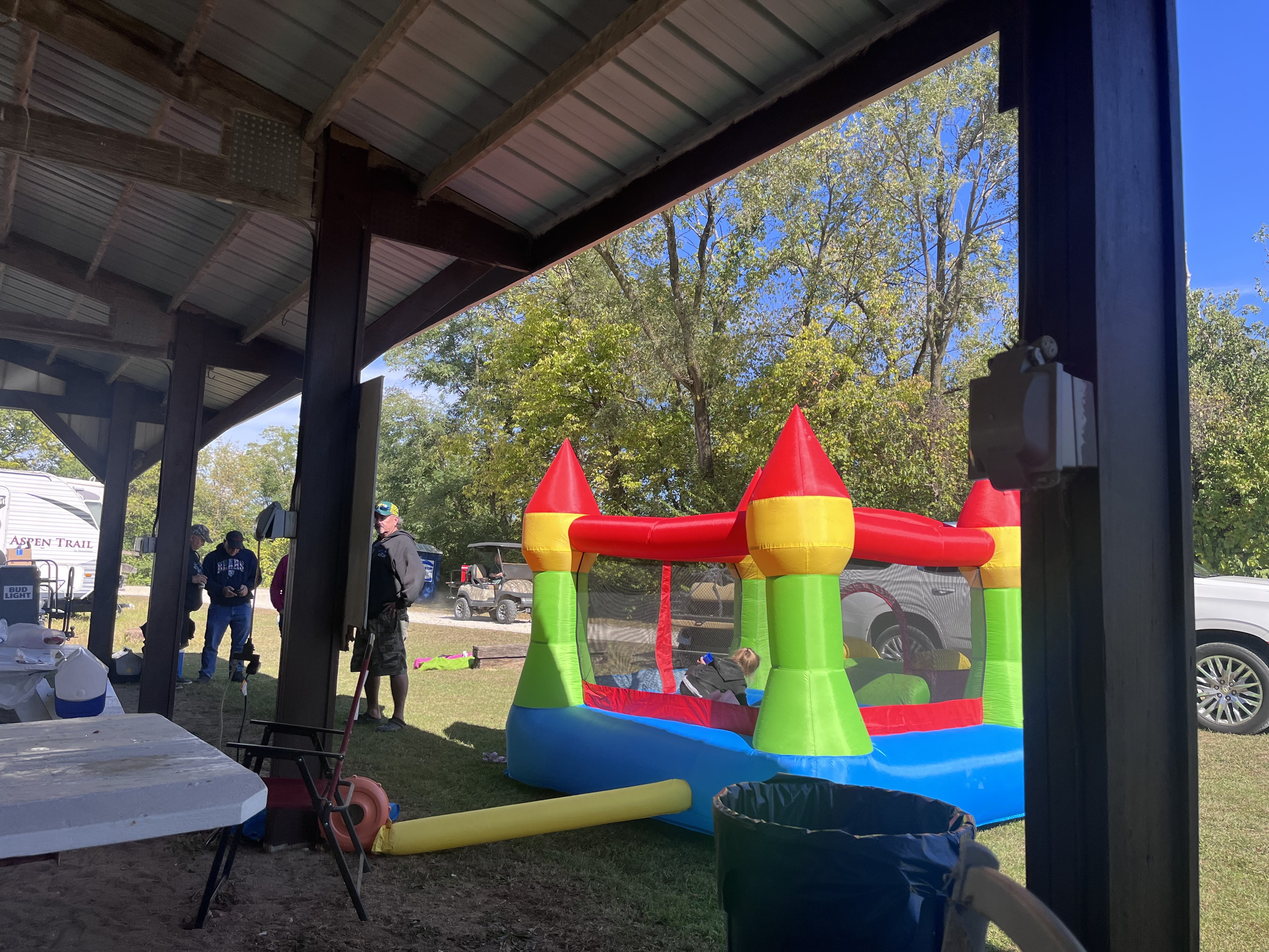 Bounce castle set up under the pavilion at a Deer Creek Recreation Club family event
