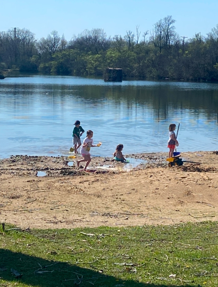 Children playing and swimming at the Deer Creek Recreation Club private lake beach in Plainfield Illinois