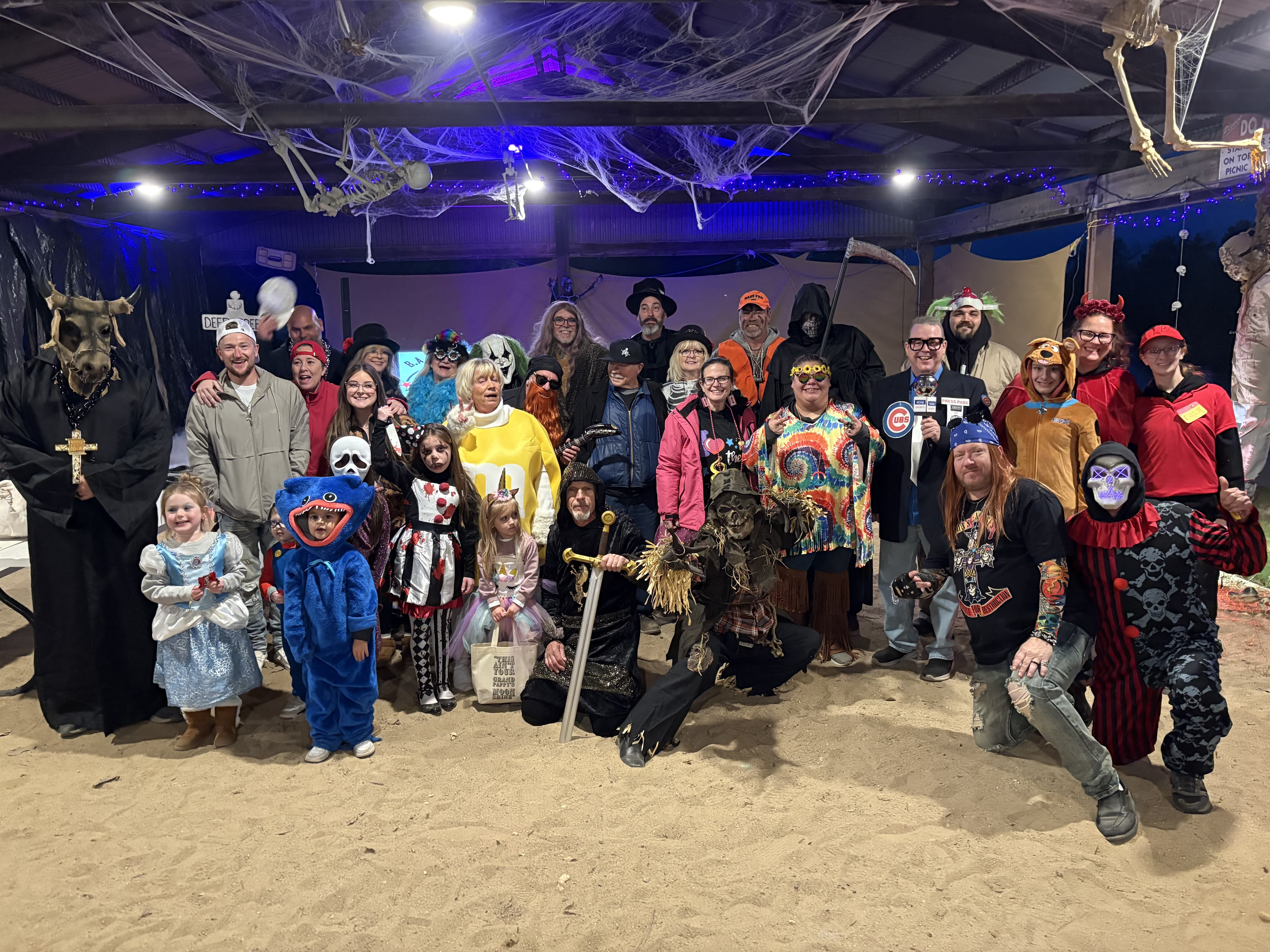 Large group of Deer Creek members in elaborate Halloween costumes at the annual pavilion party