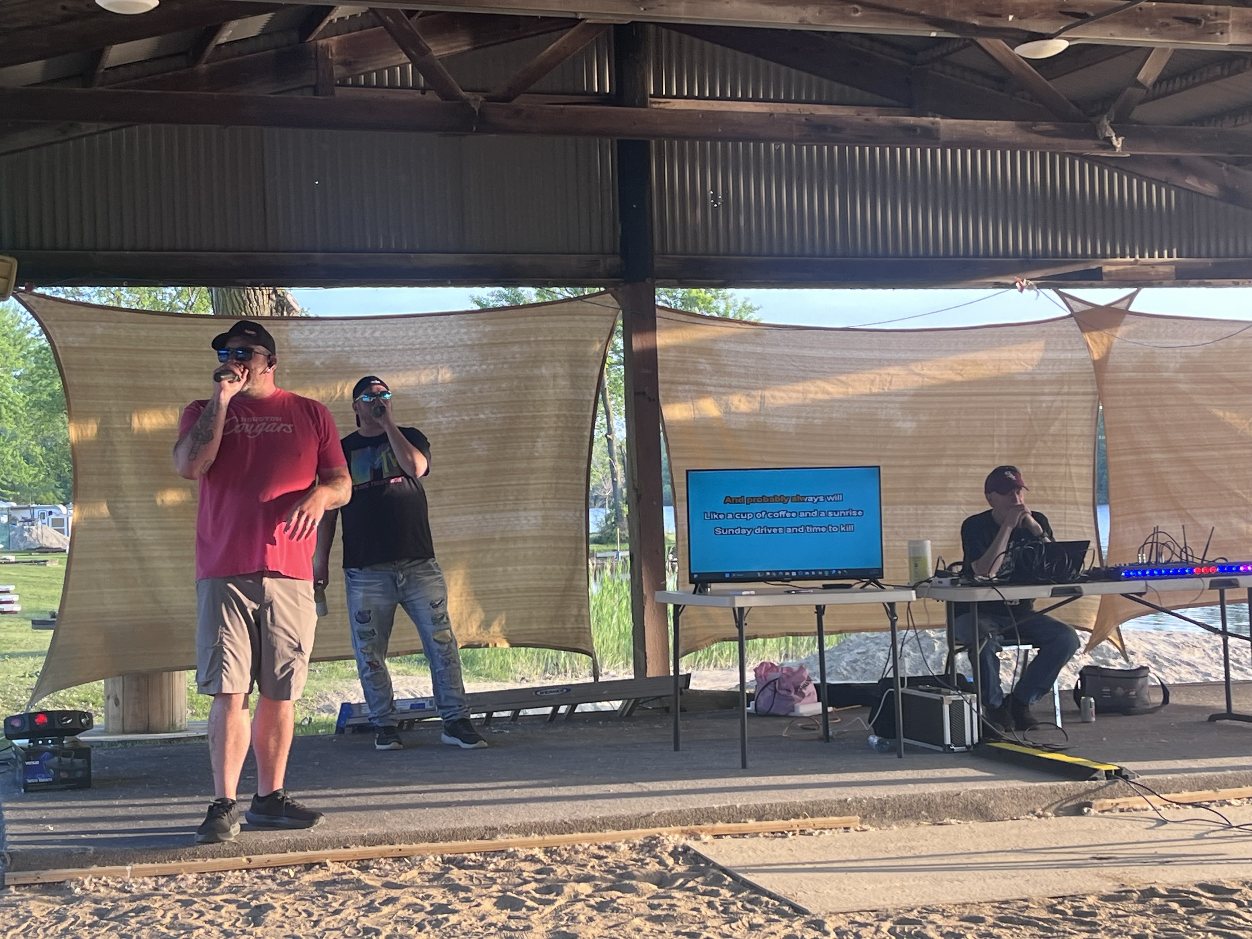 Members performing karaoke at the Deer Creek beach pavilion during a club event