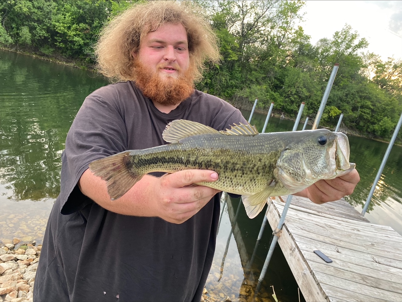 Largemouth bass held up at sunset on the dock at Deer Creek Lake
