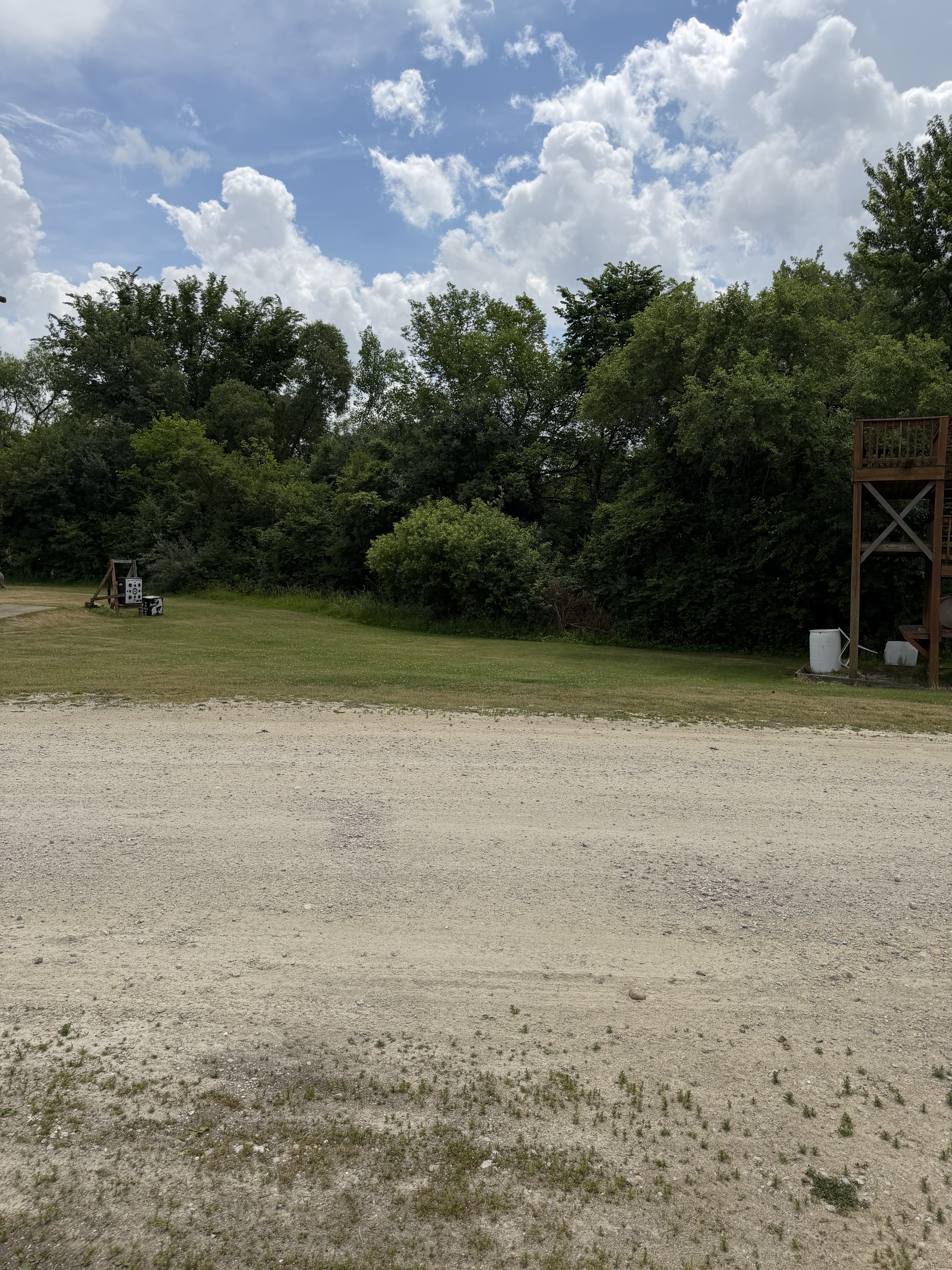 Wide view of the Deer Creek Recreation Club trap field with shooting pad and Trap House tower visible